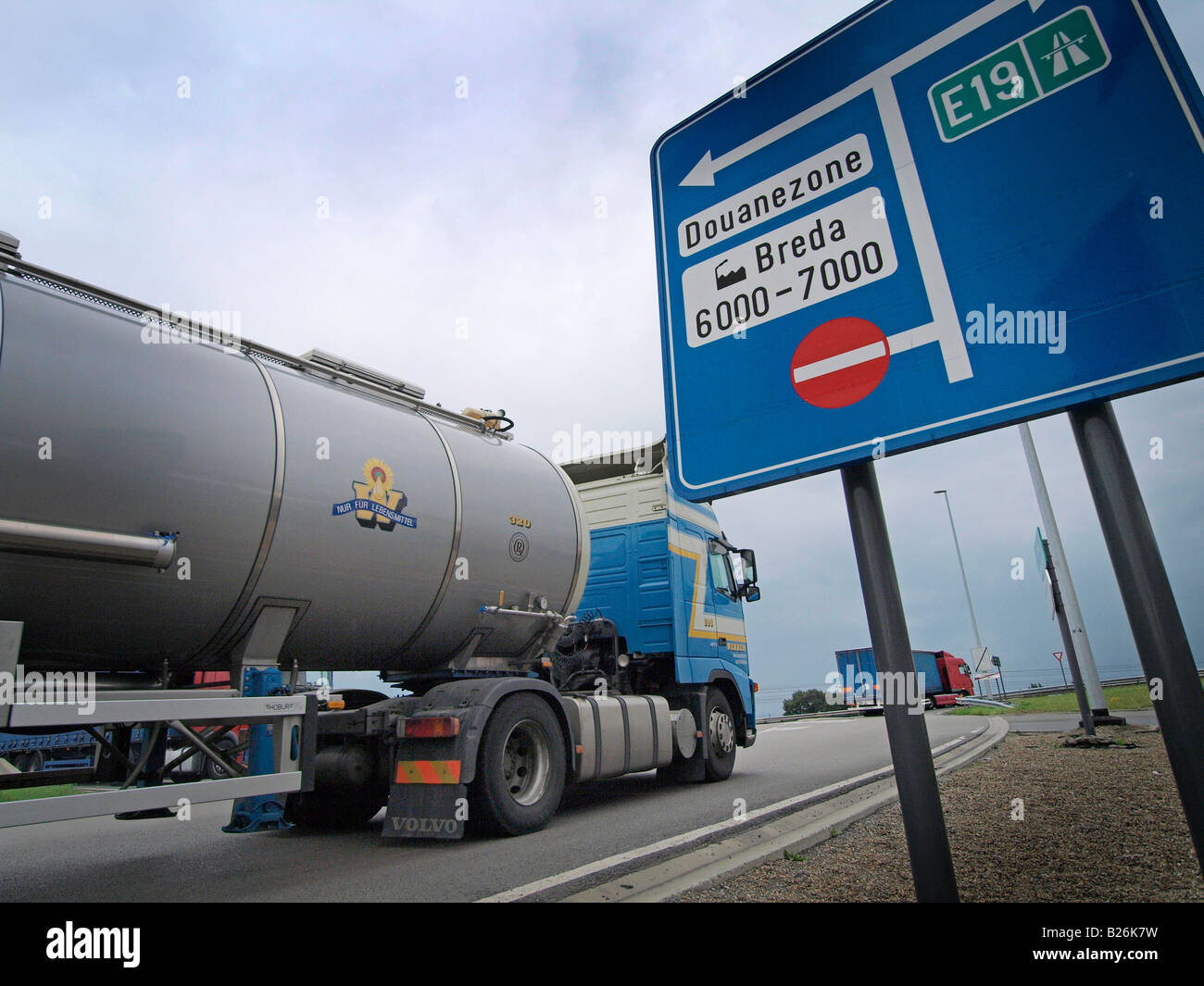 Trucks at the Dutch Belgian border in Hazeldonk along the E19 highway import export international trade Stock Photo