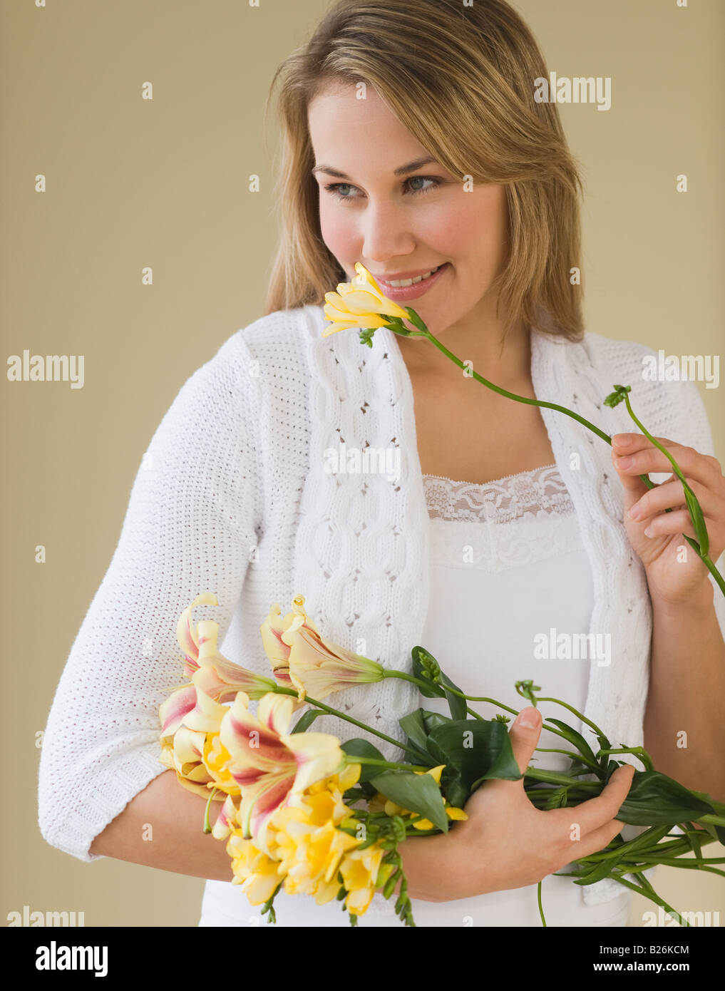 Woman smelling cut flower Stock Photo