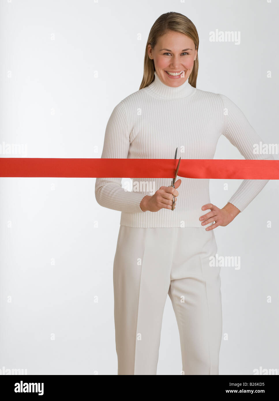 Woman cutting red tape Stock Photo