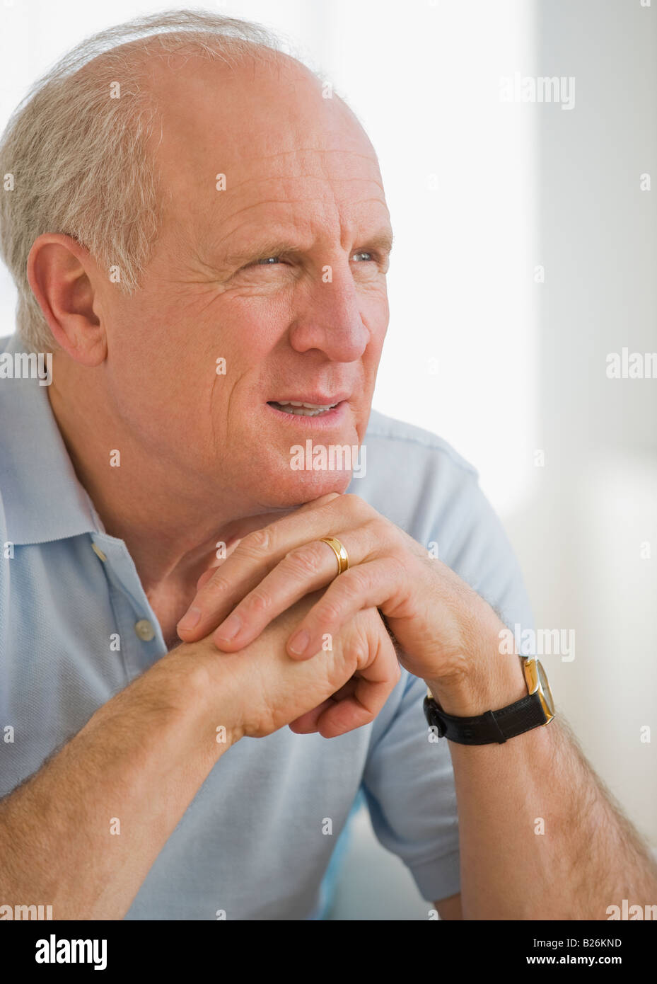 Senior man resting chin on hands Stock Photo Alamy