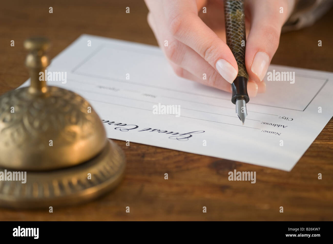 Woman filling out hotel registration Stock Photo