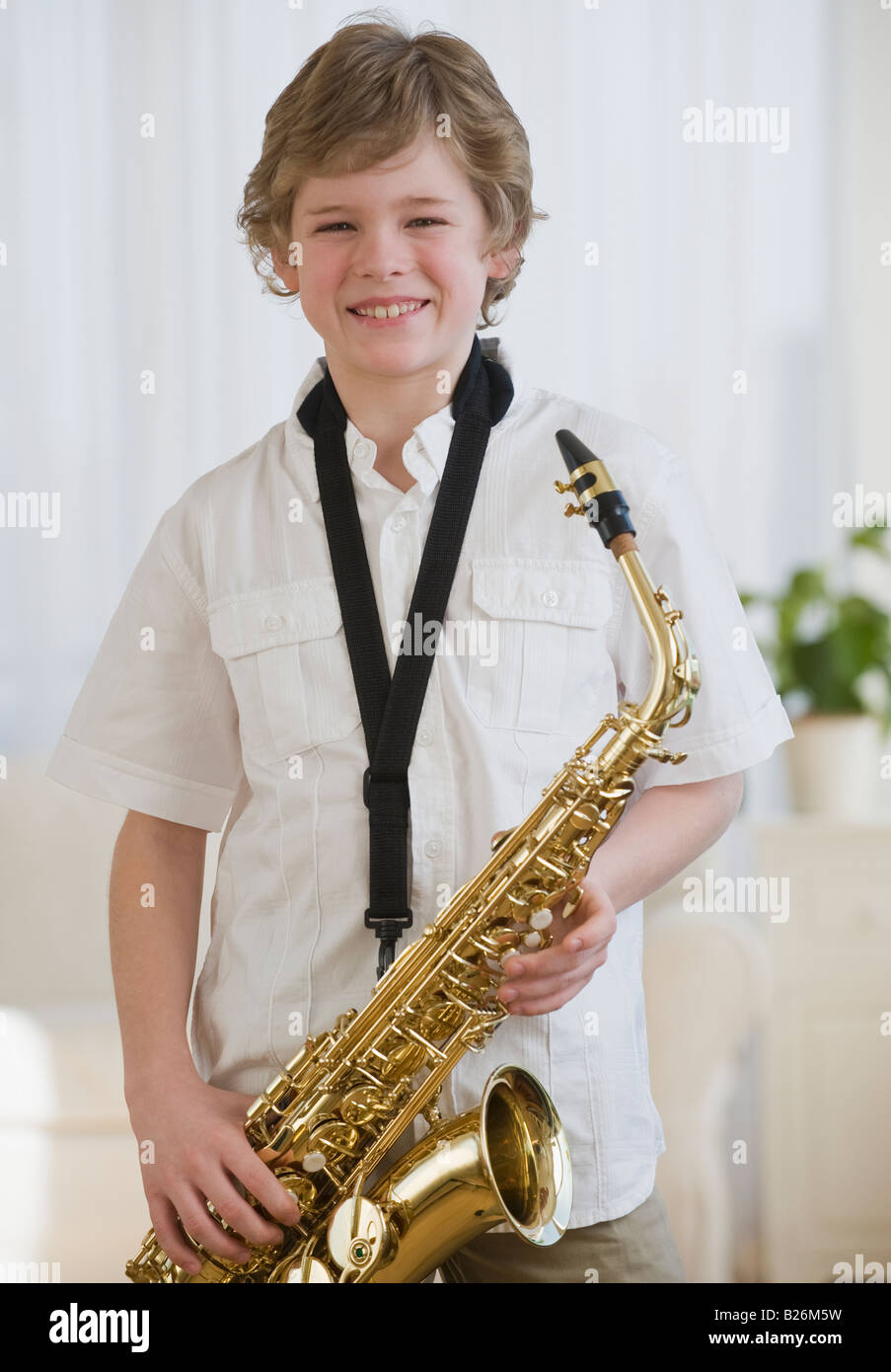 Boy holding saxophone Stock Photo