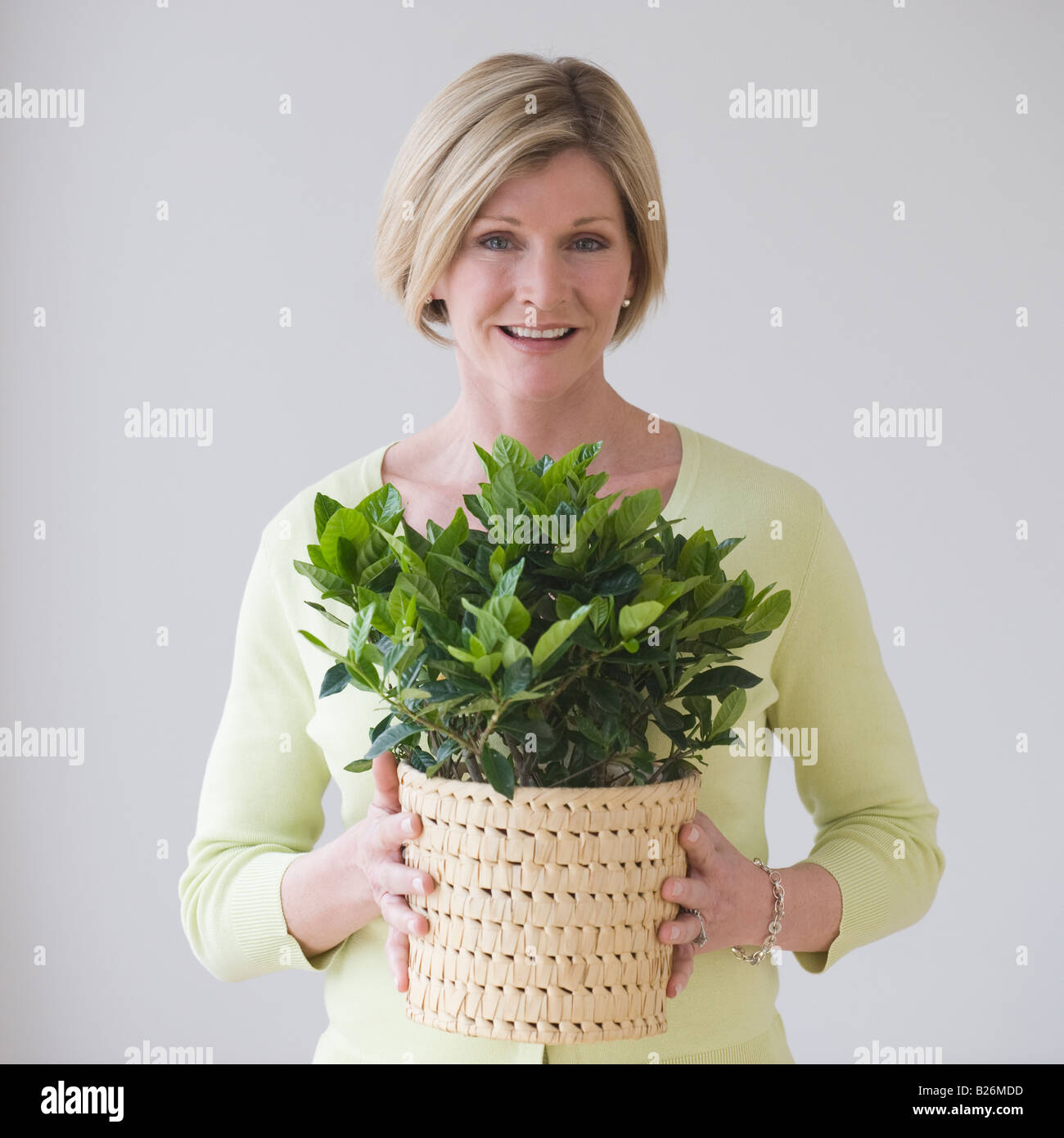 Woman holding potted plant Stock Photo - Alamy
