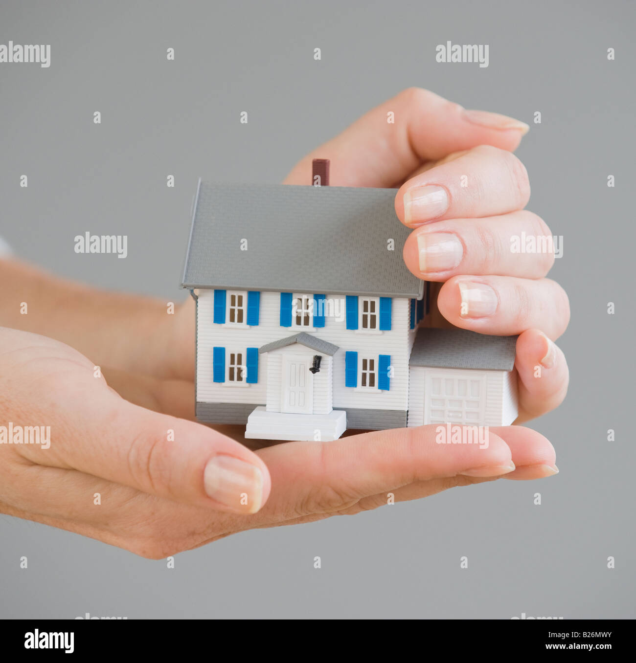 Woman holding model house Stock Photo - Alamy