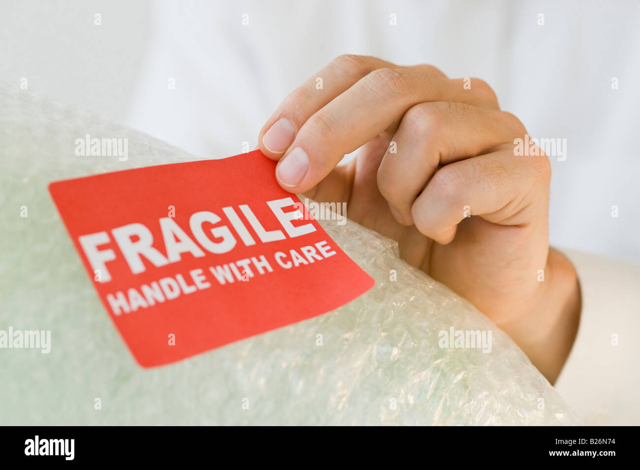 Man affixing fragile sticker Stock Photo