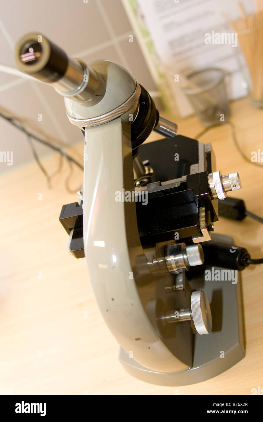 Microscope standing on table Stock Photo Alamy