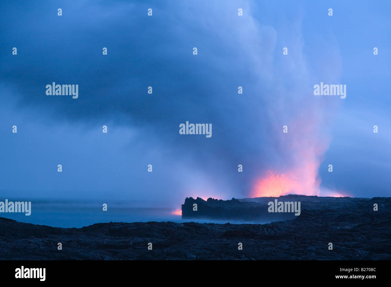 Steam clouds created as molten lava meets the sea Hawaii Volcanoes National Park Big Island Hawaii USA Stock Photo