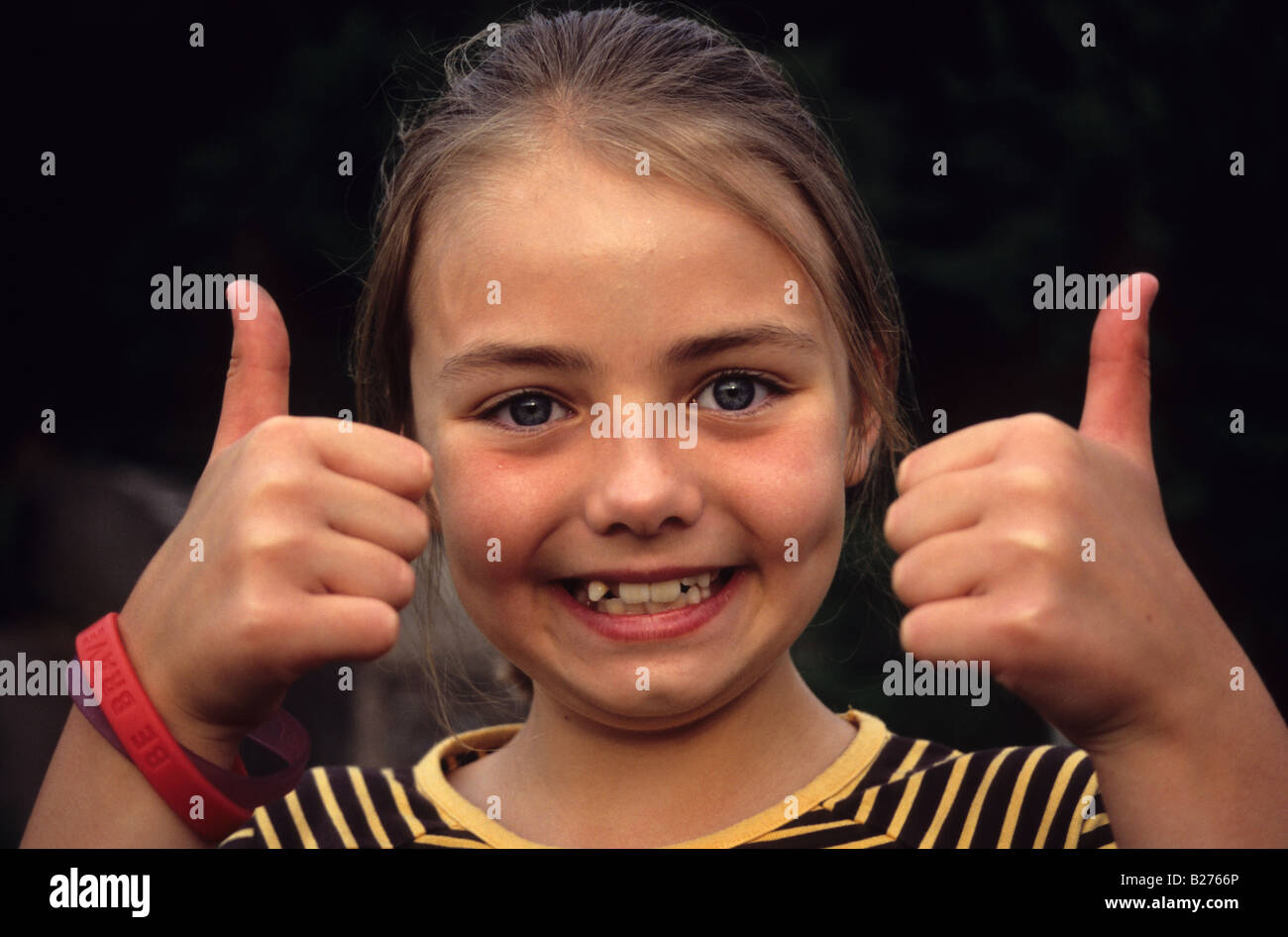 Young Girl Giving Thumbs Up Ok Sign Stock Photo