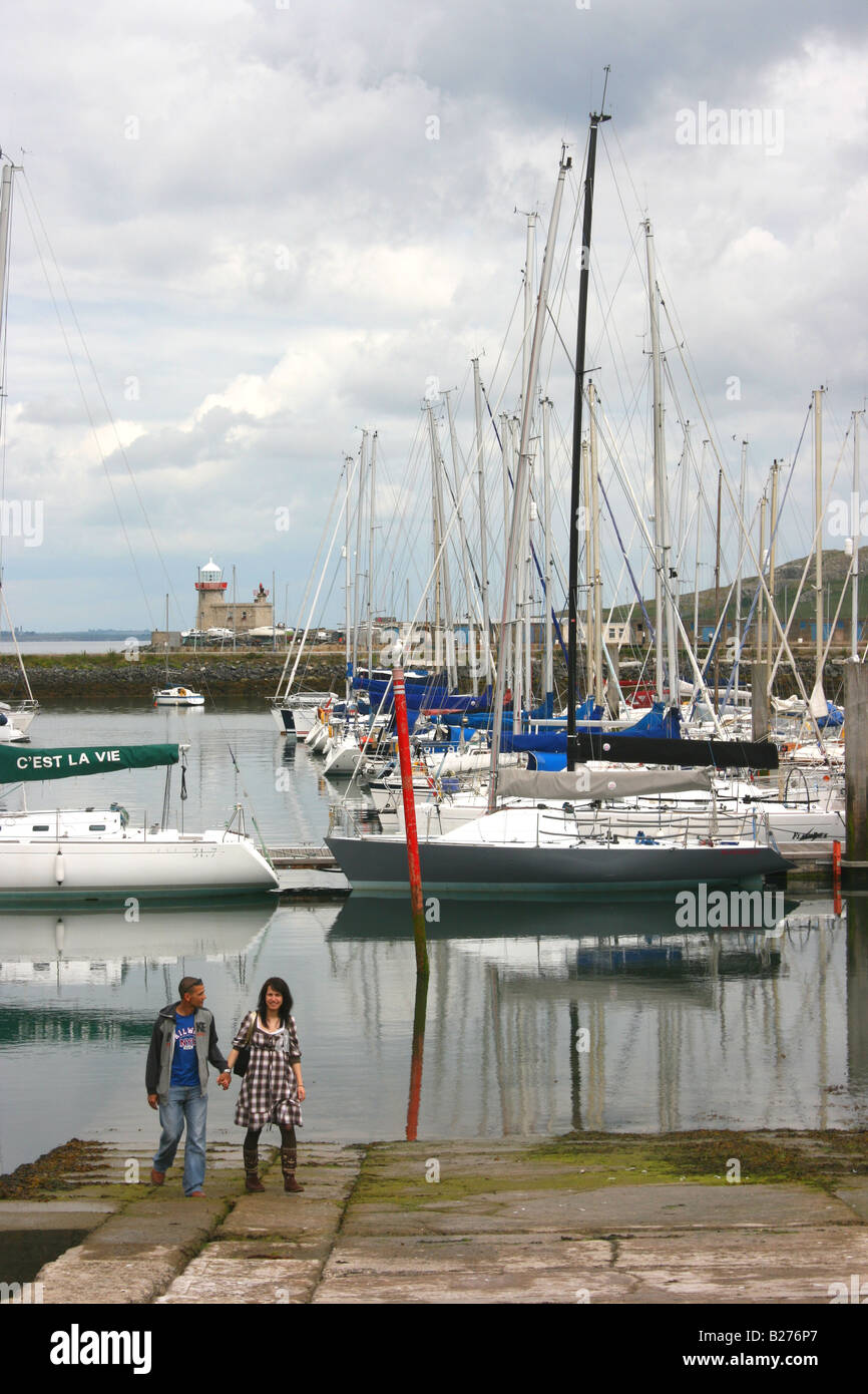 couple standing on the slipway at Howth harbour, County Dublin, Ireland Stock Photo