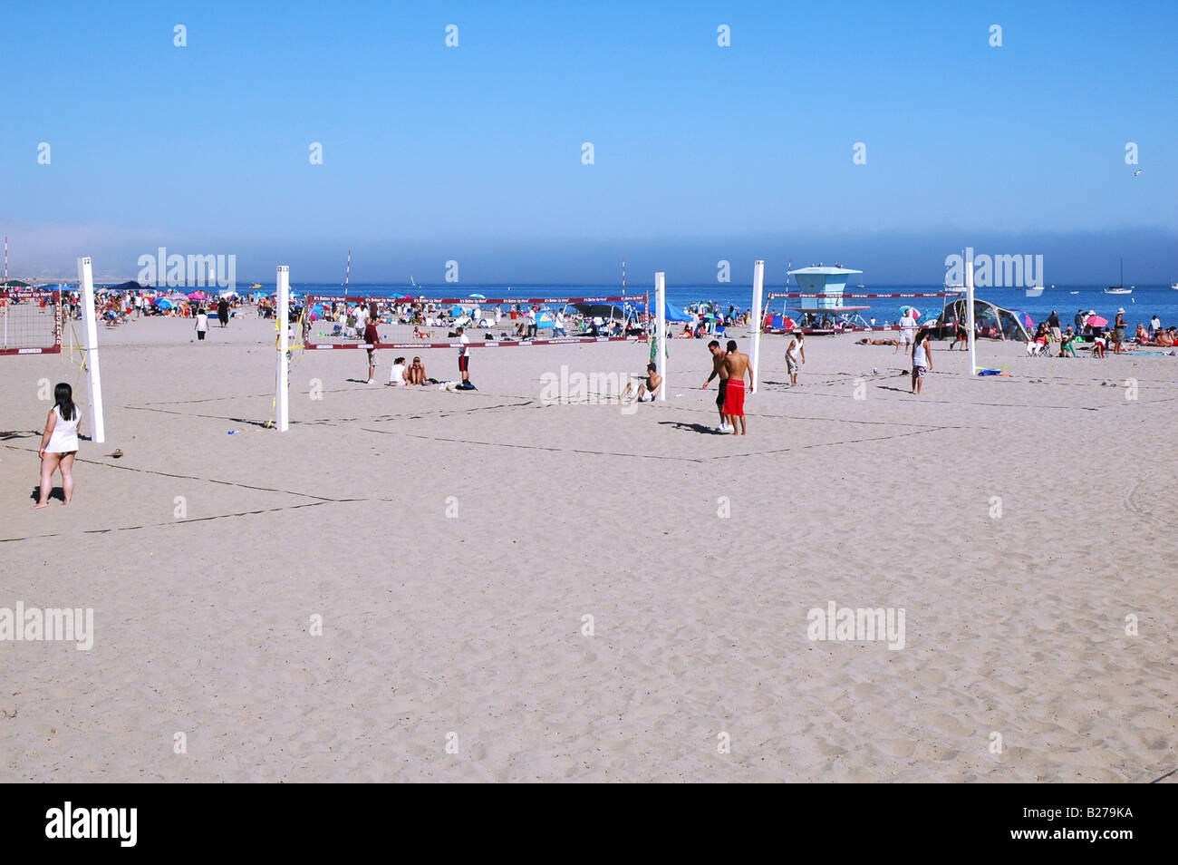 people playing volly ball on the beach in santa cruz california on a tyical blue sky perfect weather summer day Stock Photo