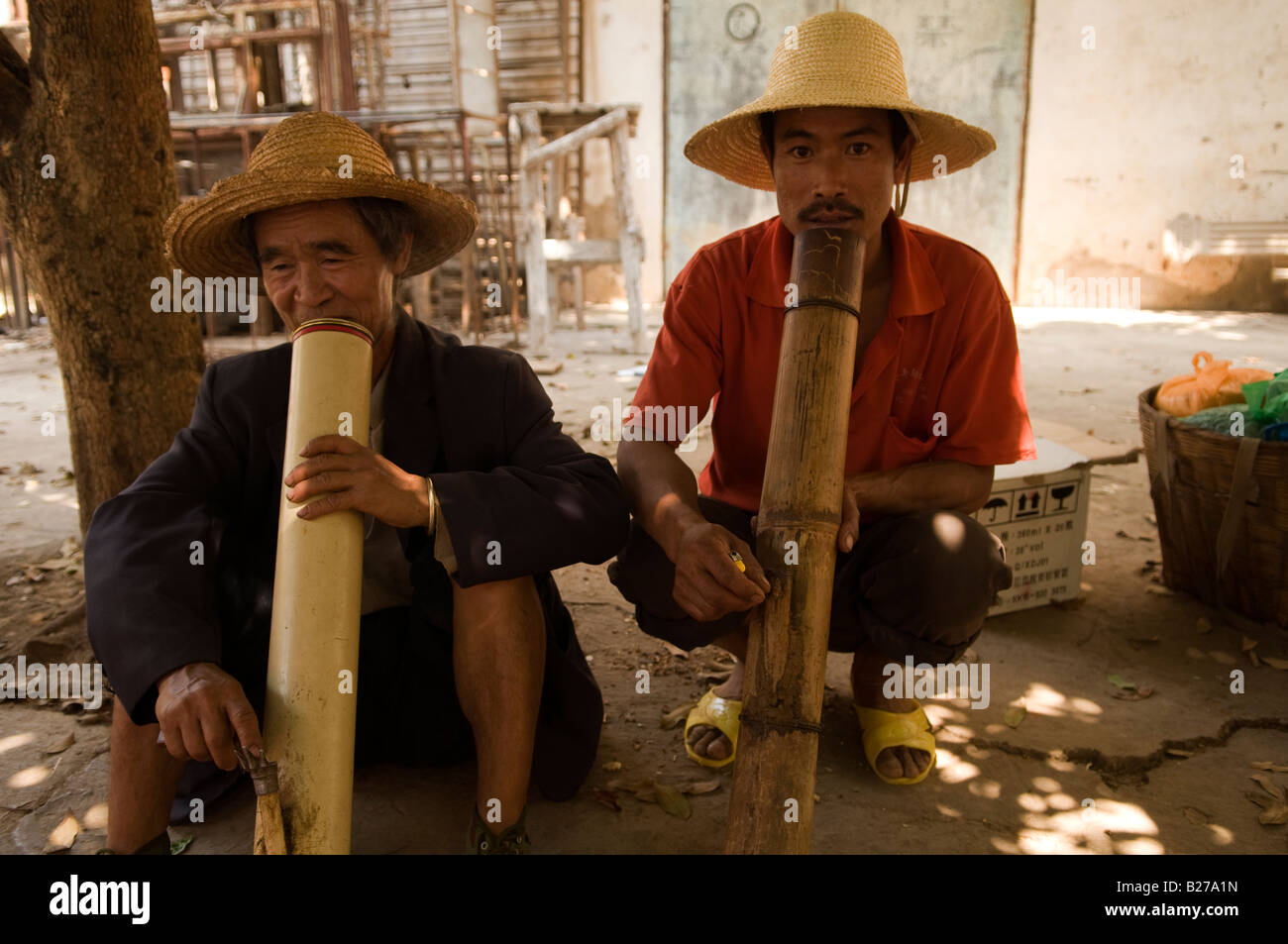 Ethnic Miao men smoke with a big bamboo pipe Stock Photo Alamy
