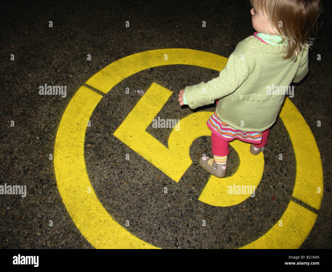 Child girl walking on 5 Km/h road sign Stock Photo - Alamy