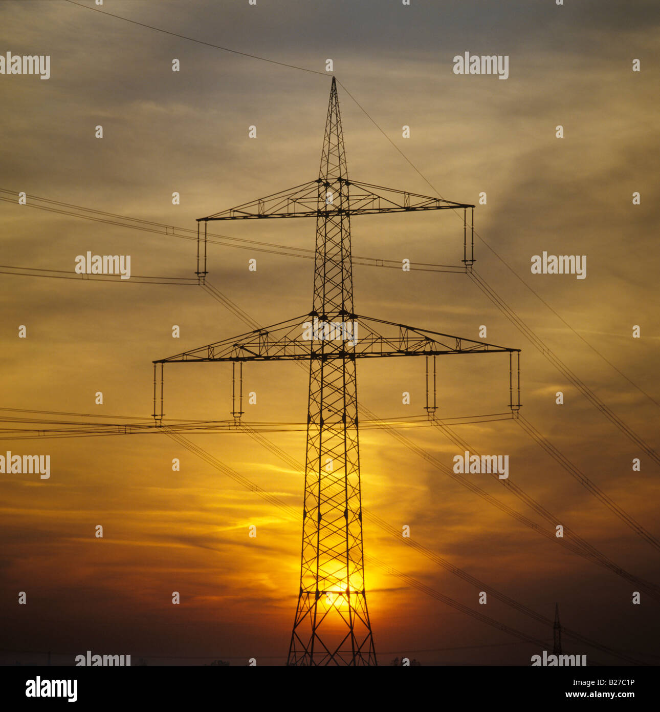 high voltage power pole during sunset North Rhine Westphalia Germany Stock Photo