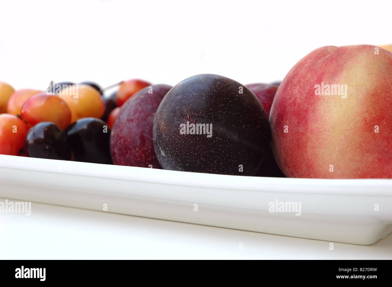 Platter of summer fruit cherries plums peaches Stock Photo Alamy
