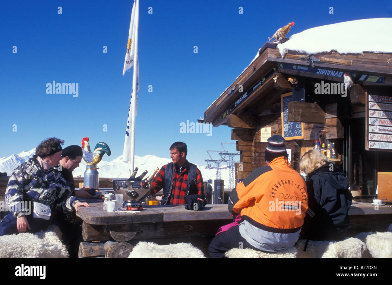 People sitting on terrace of a ski hut at the Jacobshorn mountain near
