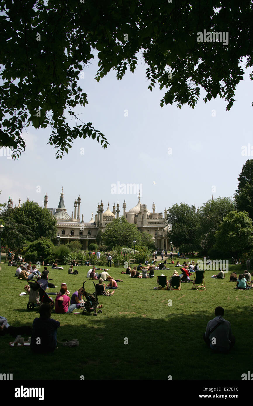 City of Brighton and Hove, England. Visitors, locals enjoying the sun on the lawns with Brighton Pavilion in the background. Stock Photo
