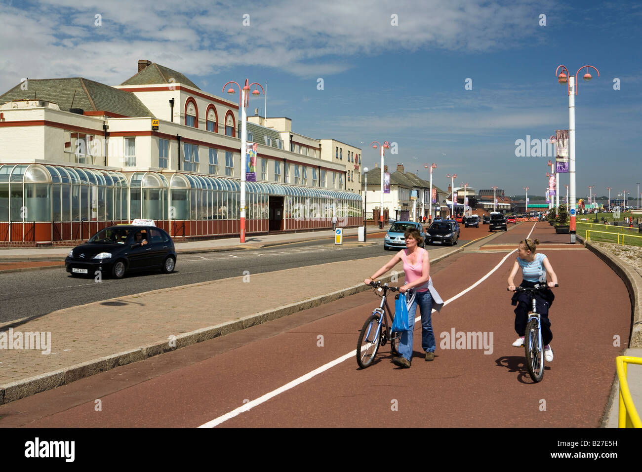UK Tyne and Wear Sunderland Seaburn two people cycling along Whitburn