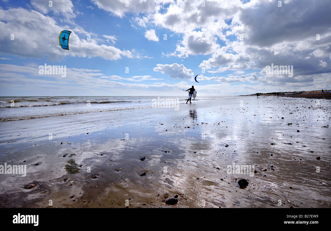 kite surfer on Goring beach near Worthing silhouetted against the sky and beach reflection. Picture by Jim Holden. Stock Photo