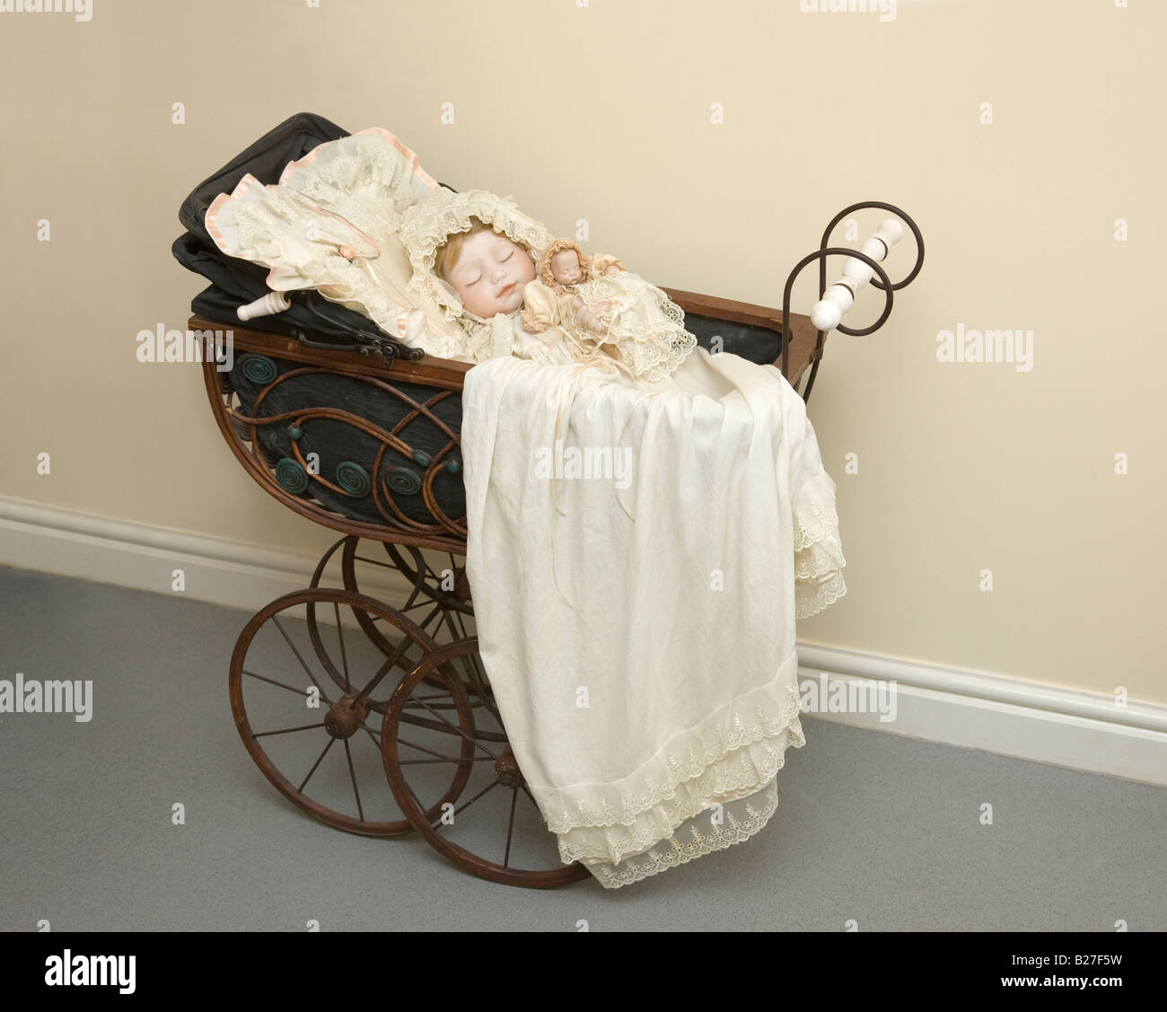 antique doll in a pram Stock Photo