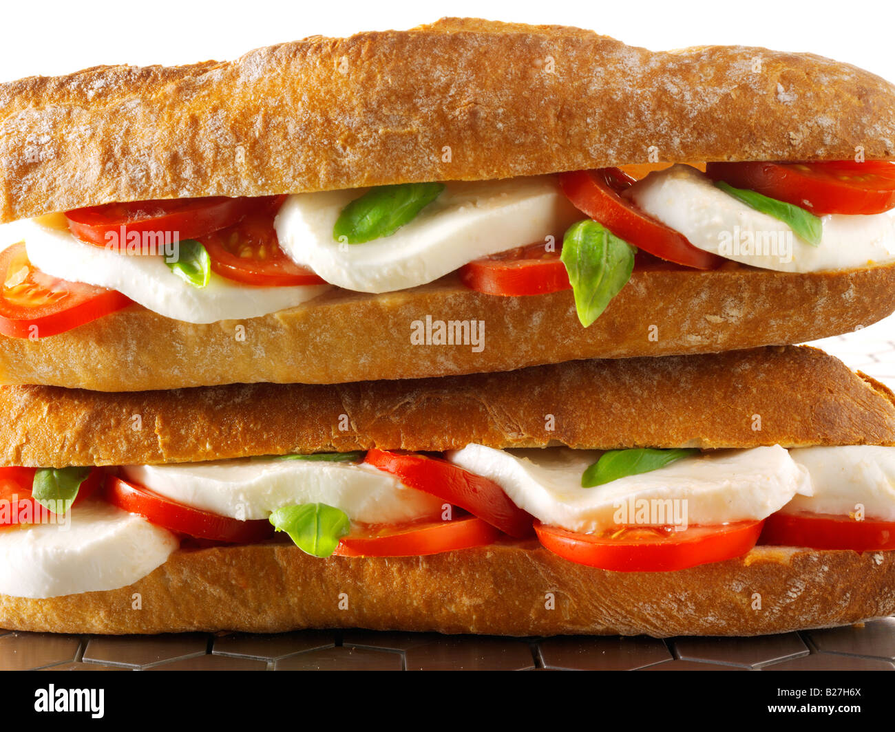 close up of mozzarella, tomato and basil  baguette in french bread stick Stock Photo