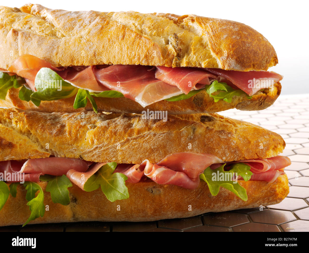close up of cheese prosciutto and salad baguette in french bread stick Stock Photo