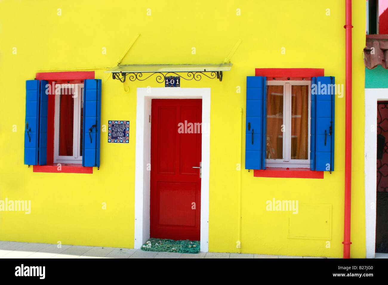 typical vividly  colorful painted houses line the streets and canals of the popular Venetian island of Burano Stock Photo