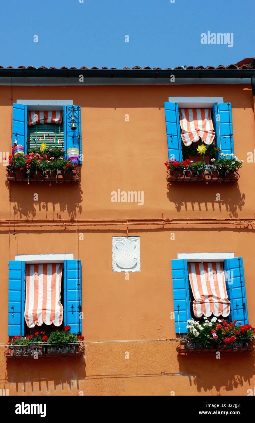 typical vividly  colorful painted houses line the streets and canals of the popular Venetian island of Burano Stock Photo