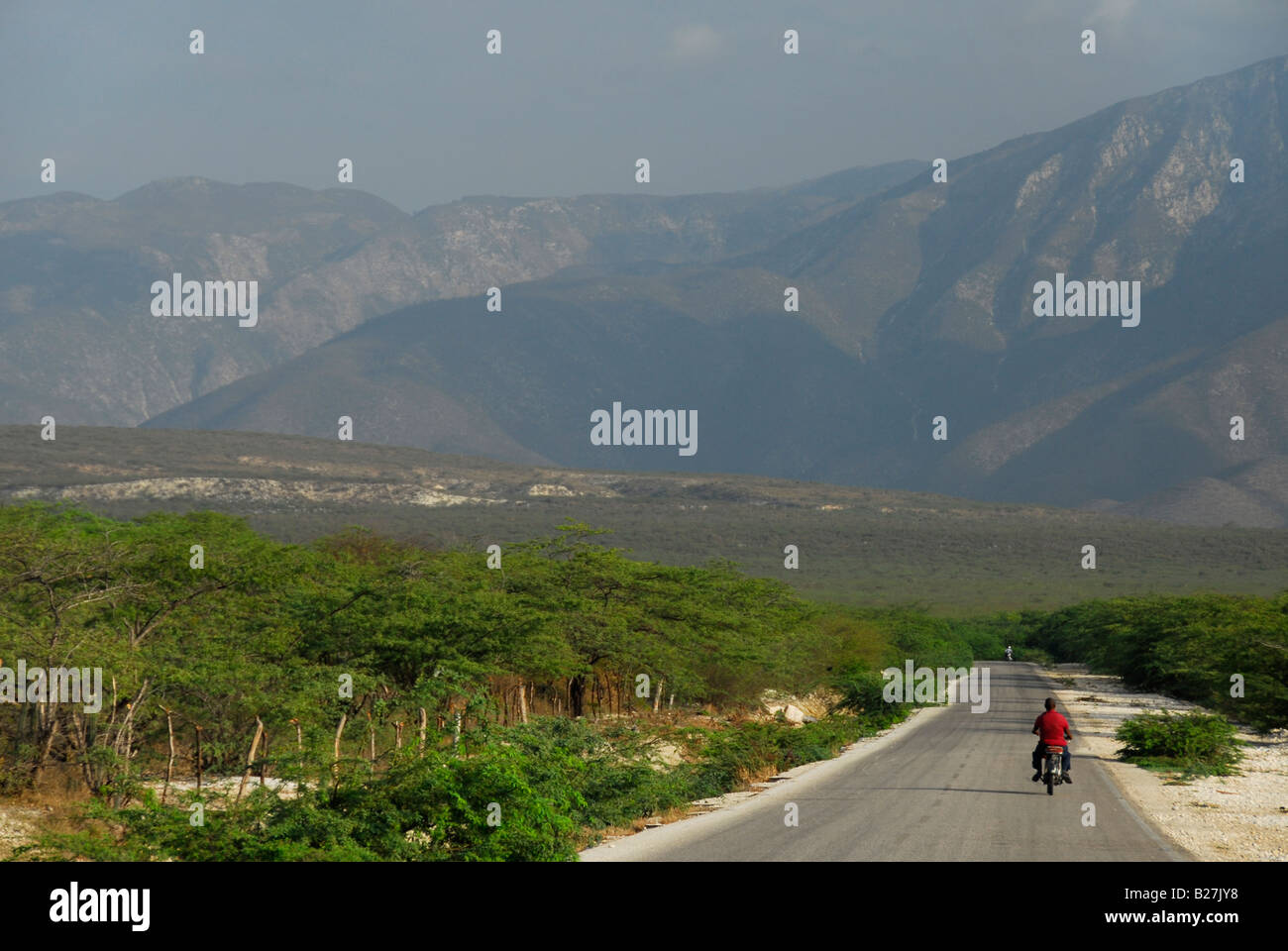 Motorcyclist on the road, coast of Lake Enriquillo, Independencia Province, Dominican Republic Stock Photo