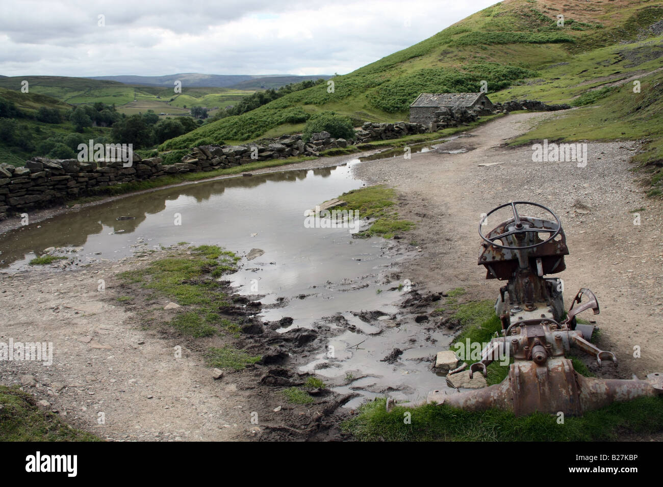 Old abandoned tractor on footpath between Keld and Muker, Upper Swaledale, North Yorkshire Stock Photo