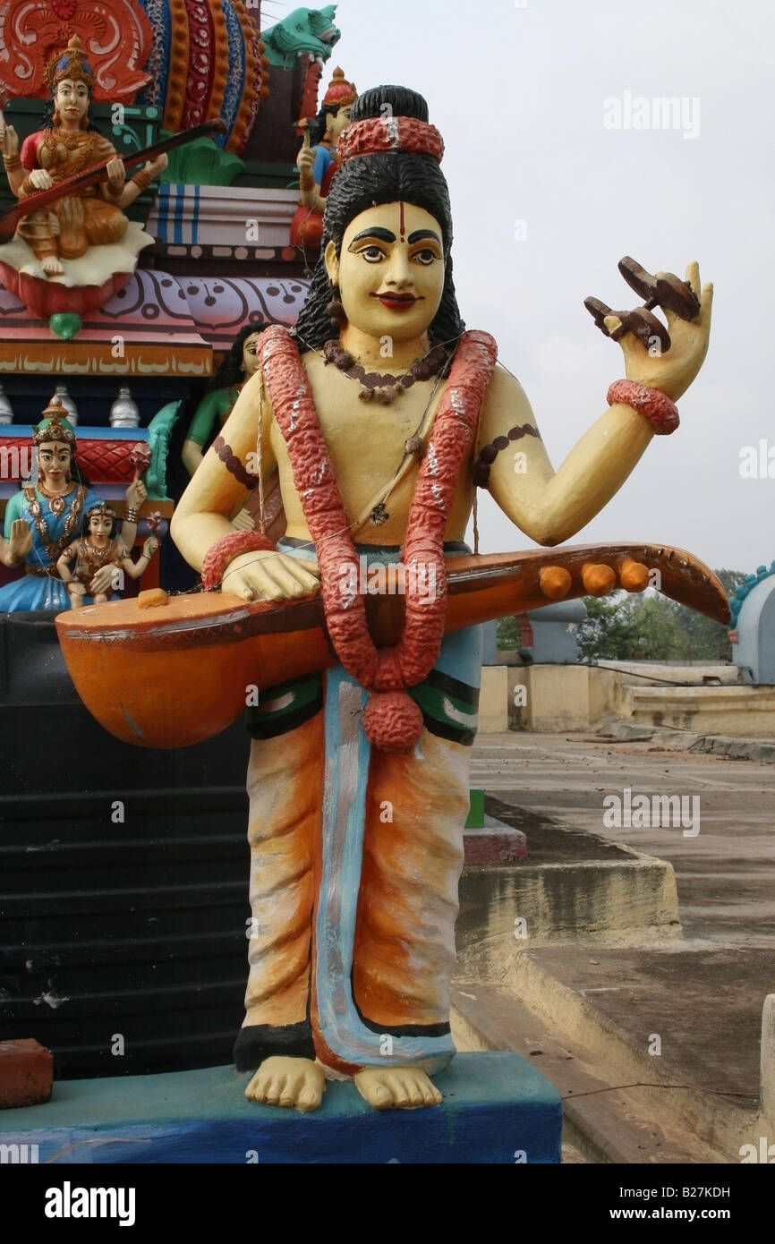 Statue on temple tower of Narad , a devotee of Lord Vishnu who was the messenger of the Gods , South India Stock Photo
