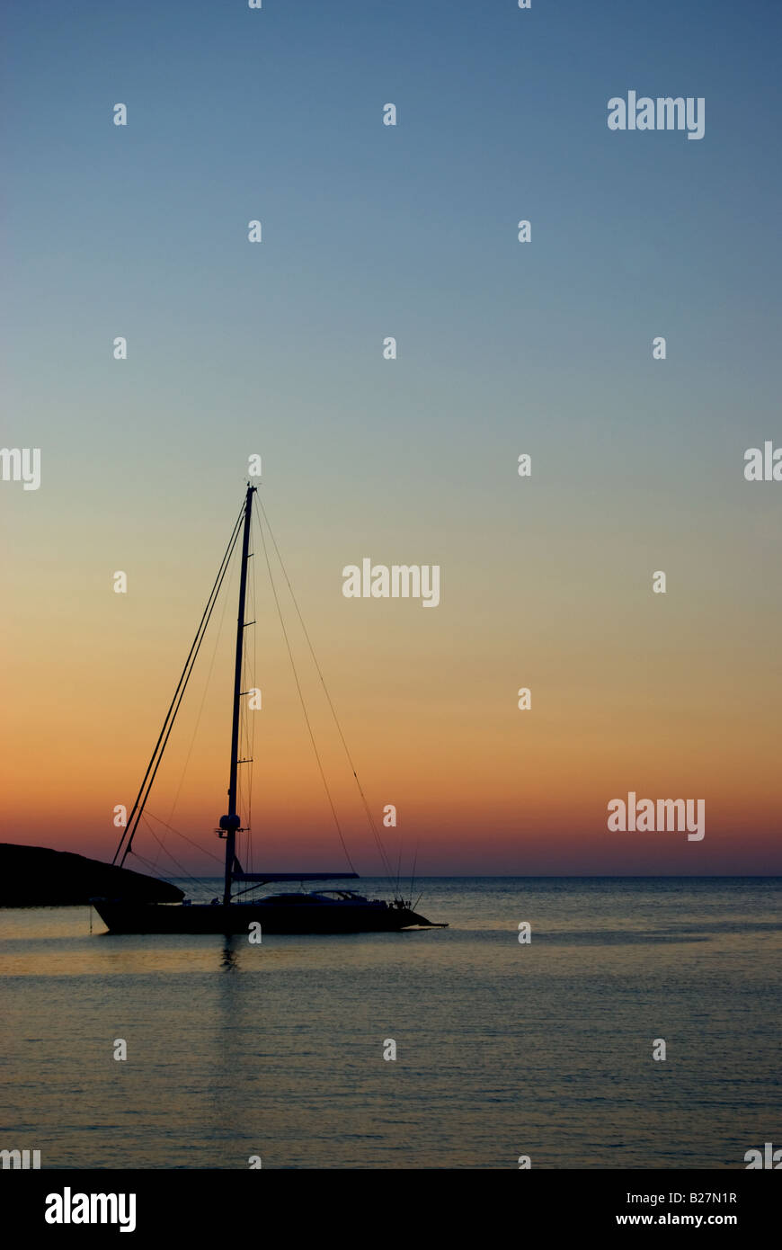 Silhouette of a boat at sunset Stock Photo - Alamy