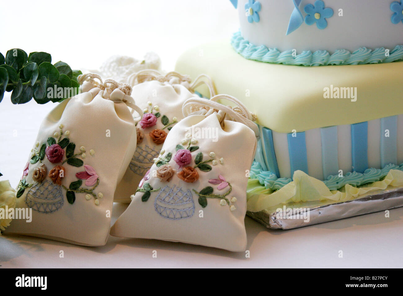 Small Souvenir Bags Used As Presents In A Baby Shower Besides A Cake
