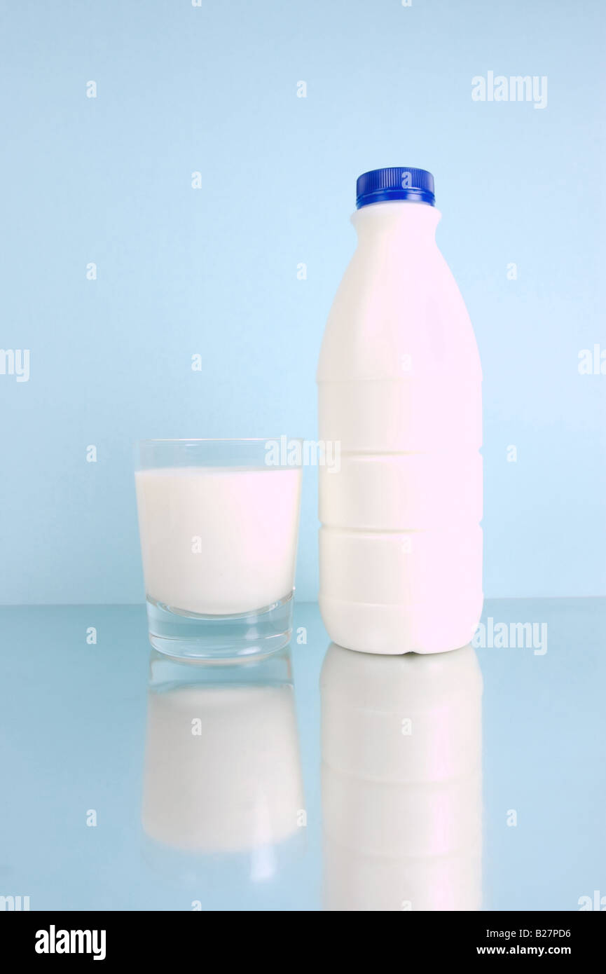 Full cream milk isolated against a blue background Stock Photo - Alamy
