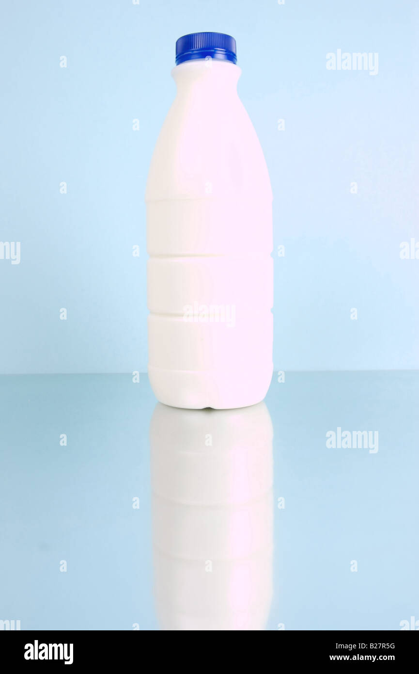Full cream milk isolated against a blue background Stock Photo - Alamy