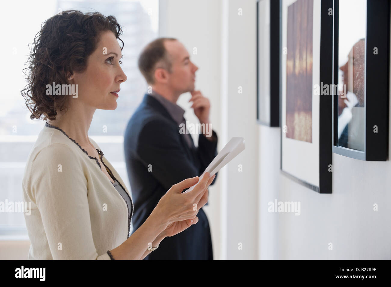 Couple looking at art in art gallery Stock Photo