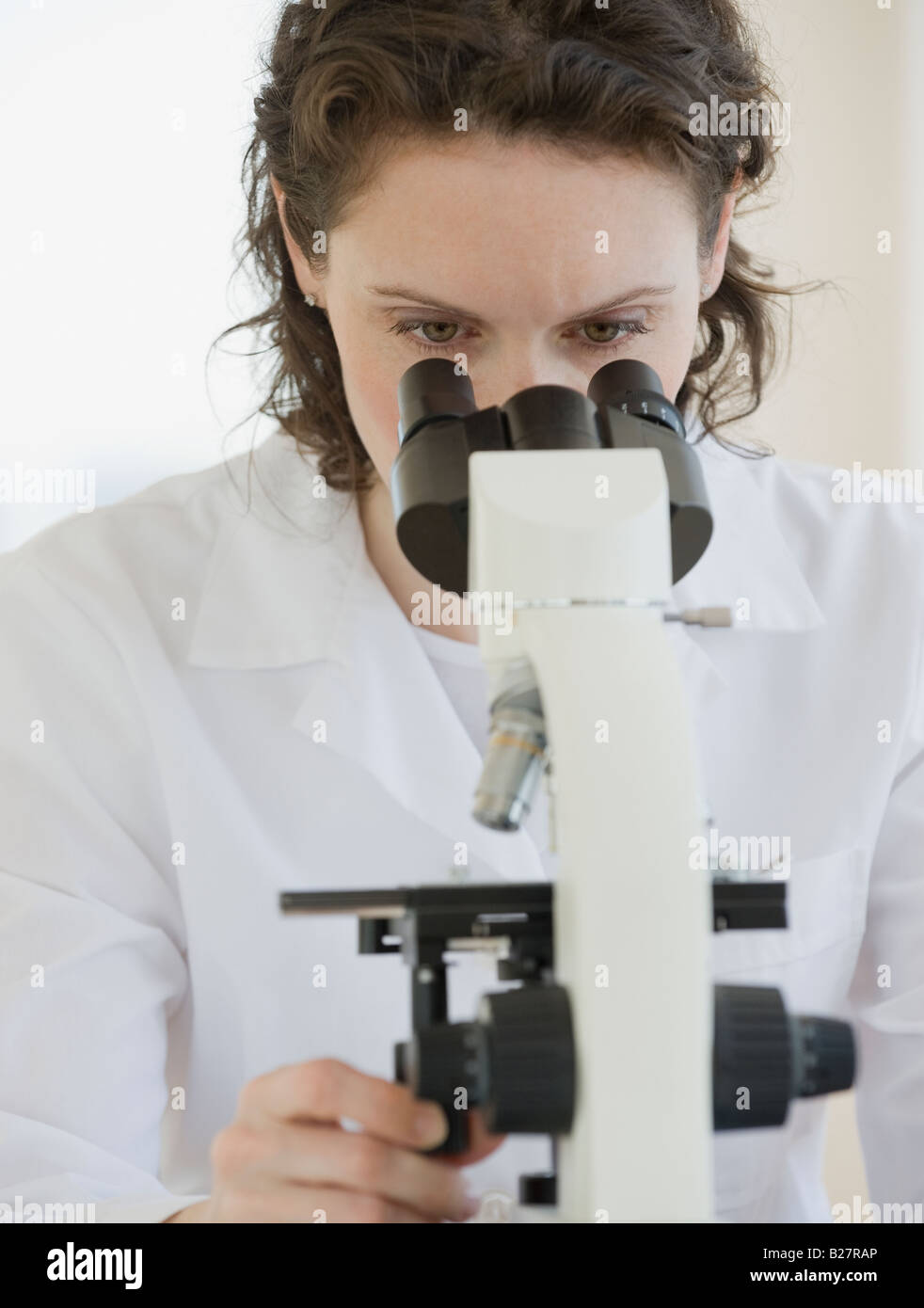 Female scientist looking into microscope Stock Photo Alamy