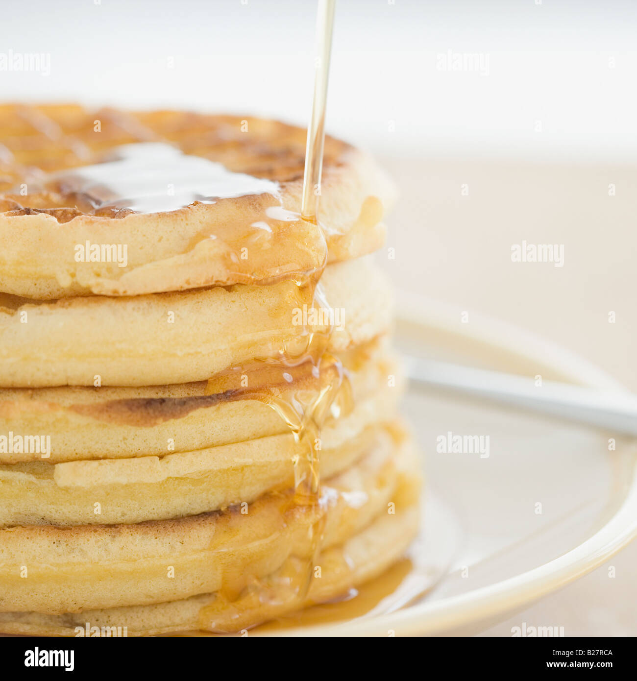 Close up of syrup pouring on waffles Stock Photo Alamy