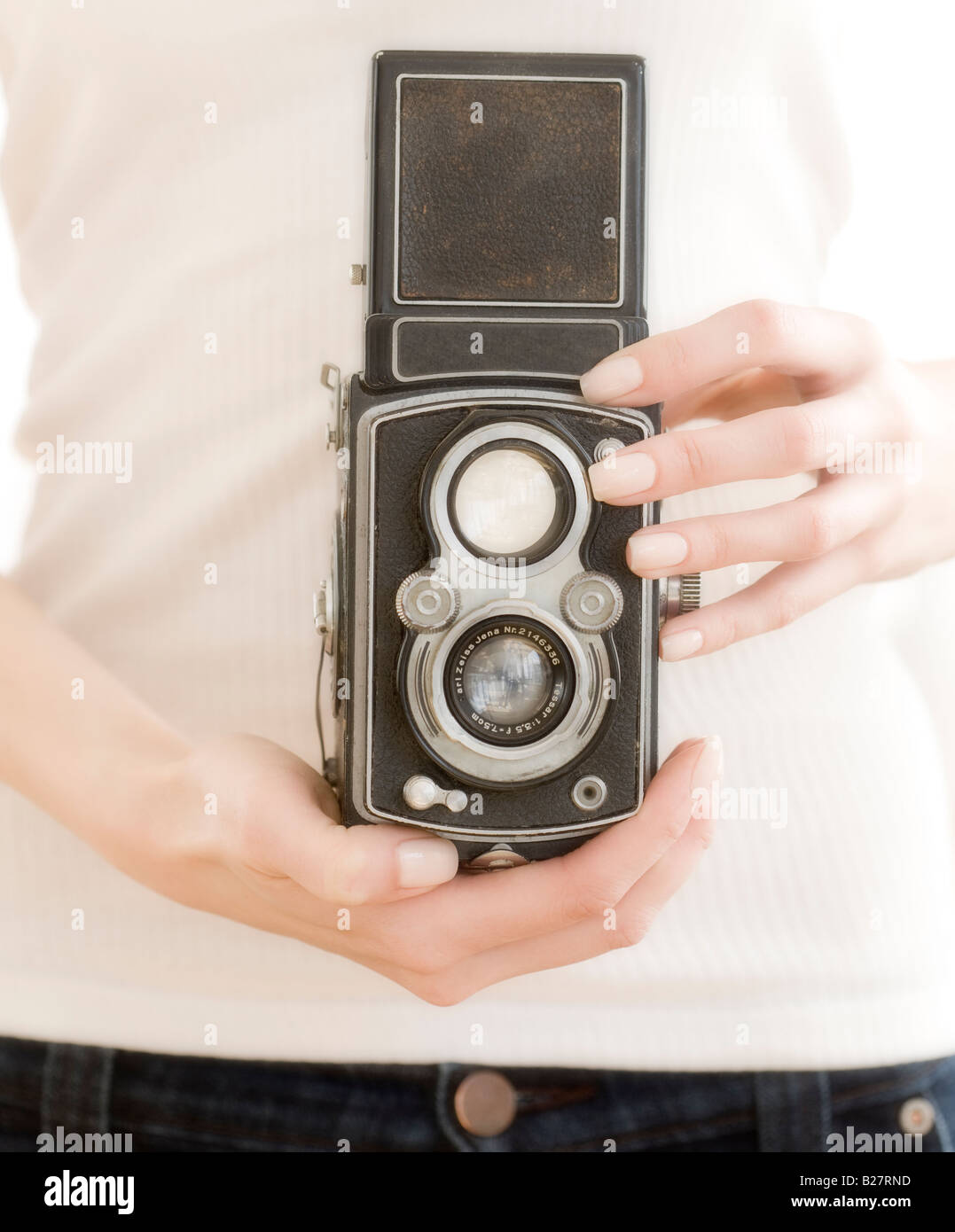 Woman holding old fashioned camera Stock Photo