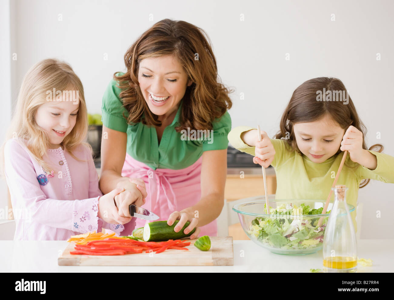 Mother and daughters preparing food Stock Photo