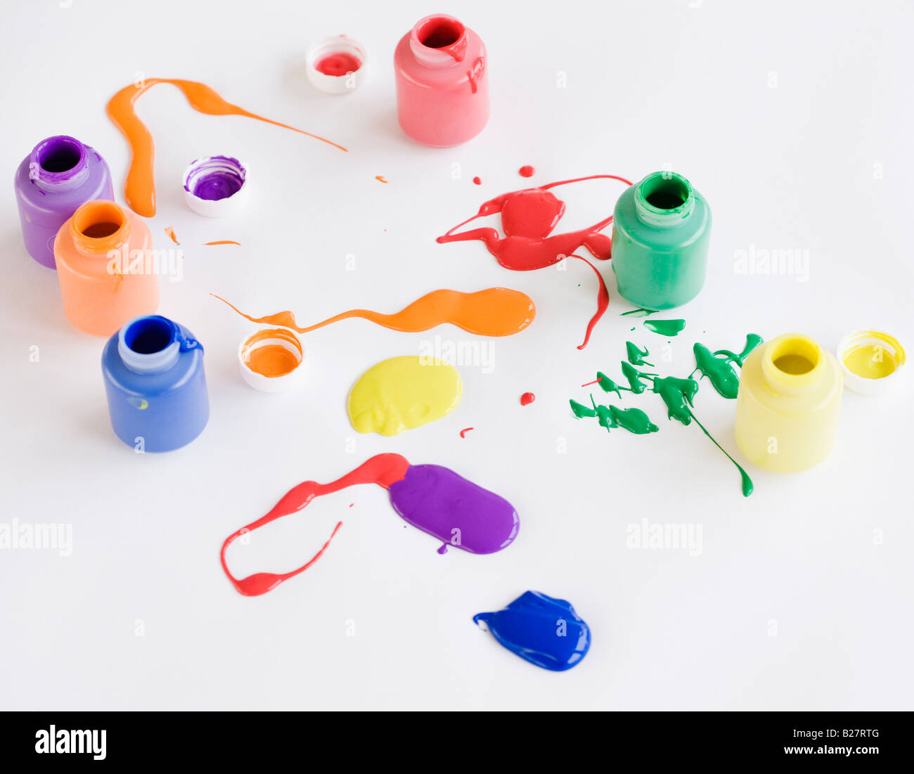 Assorted paints spilled on floor Stock Photo