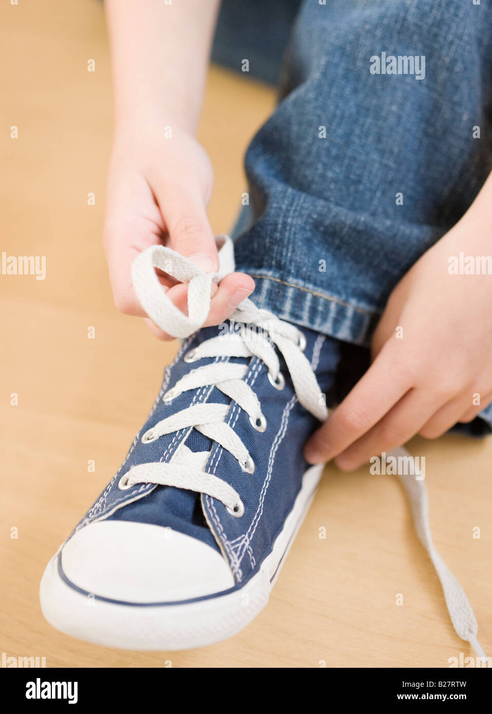 Child tying shoe hi-res stock photography and images - Alamy