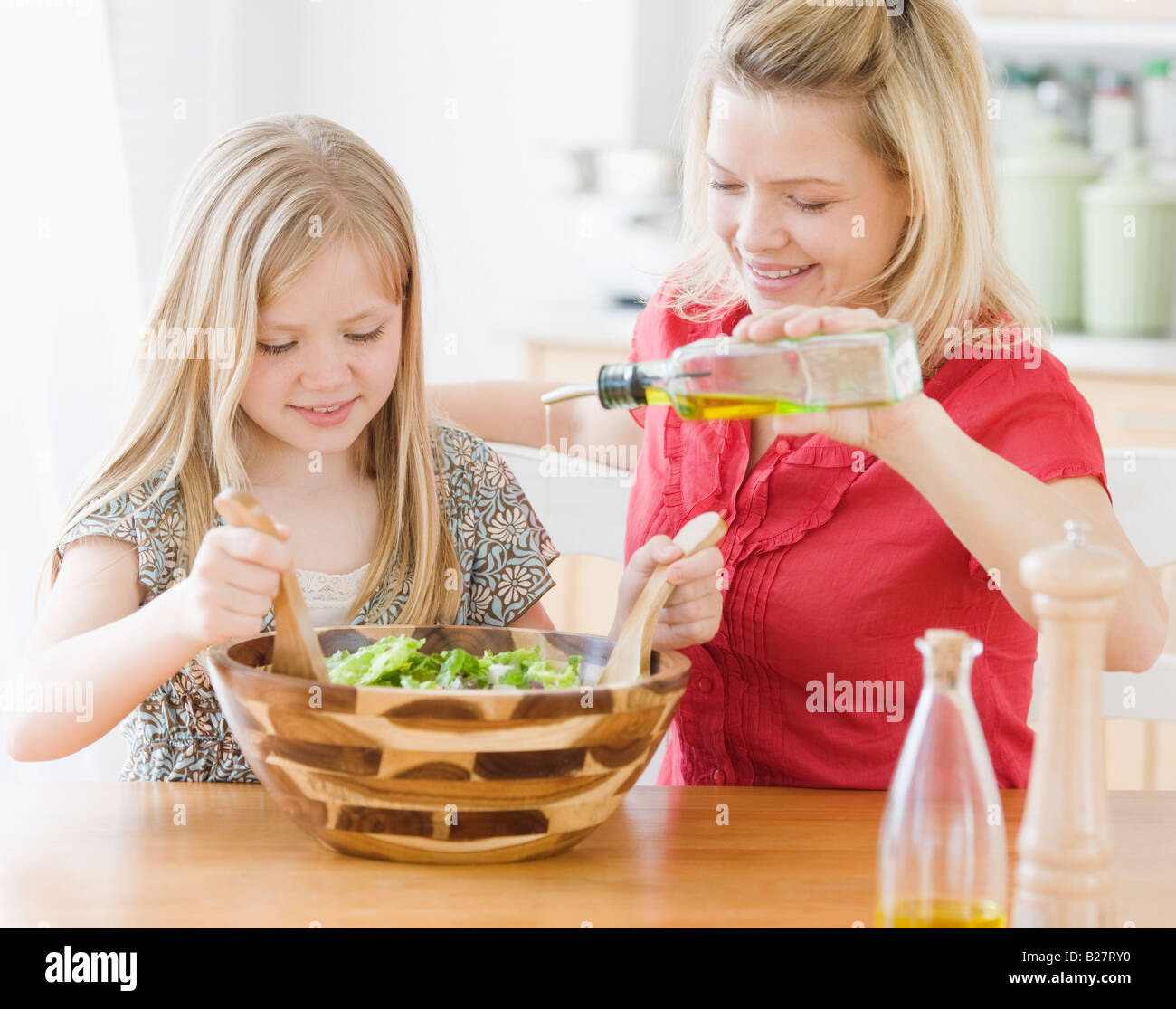 Mother and daughter making salad Stock Photo