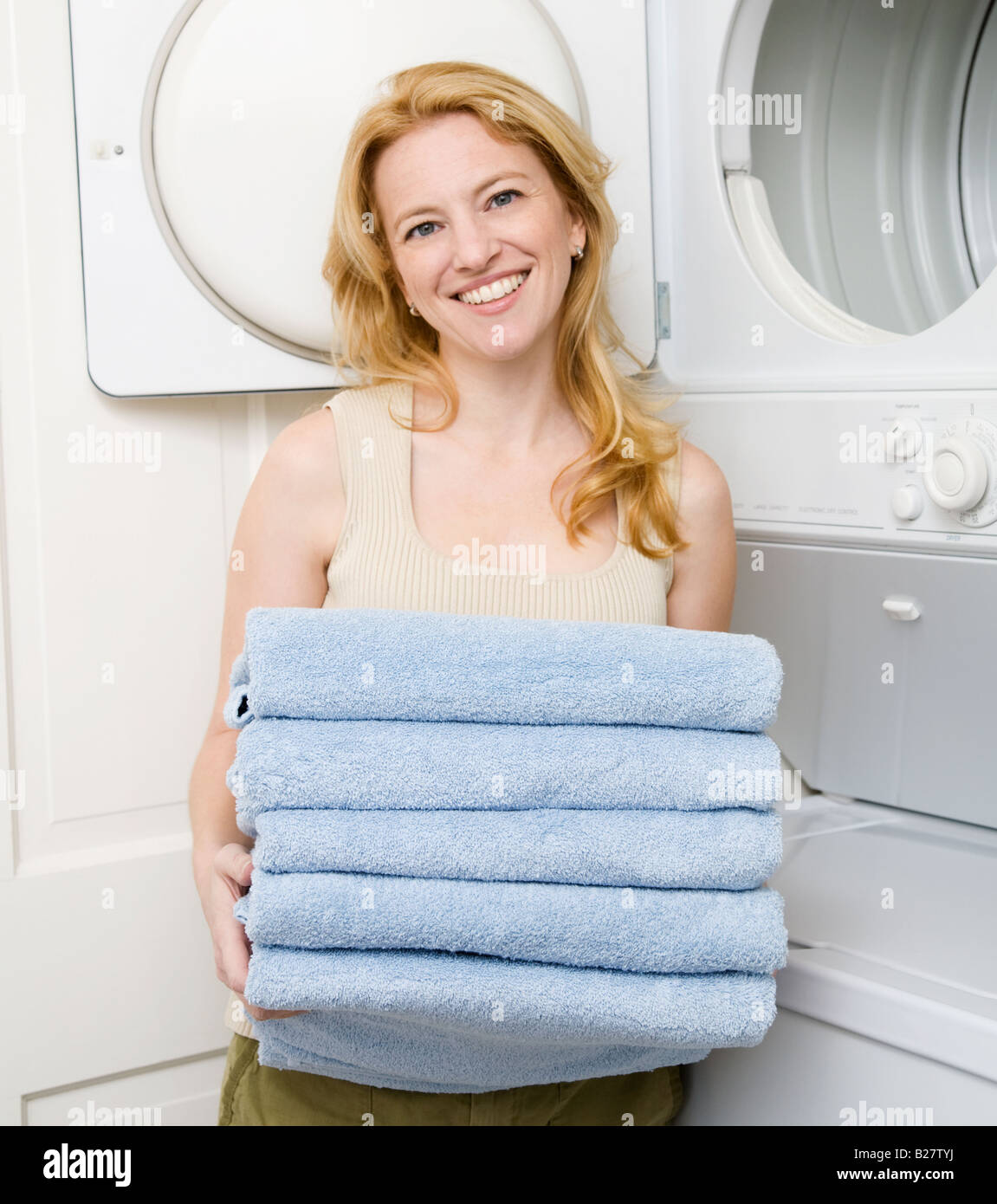 Woman holding folded towels Stock Photo
