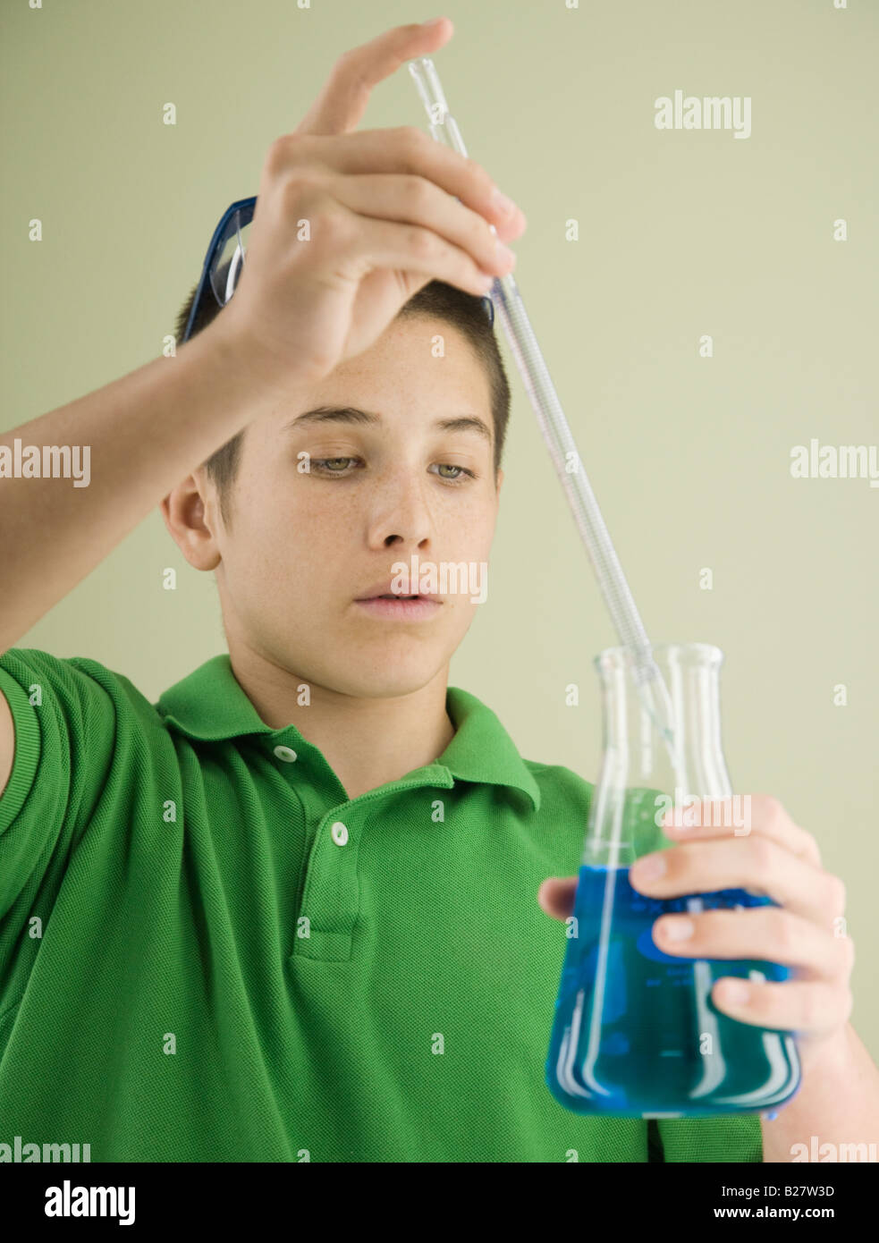 Boy measuring liquid in beaker Stock Photo Alamy