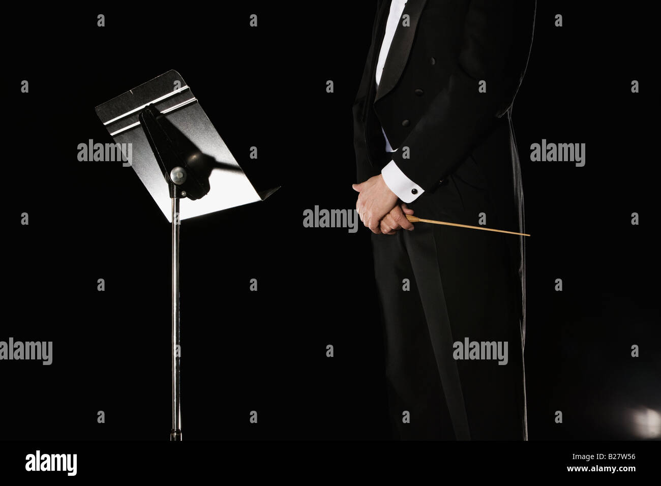 Male conductor standing next to music stand Stock Photo - Alamy