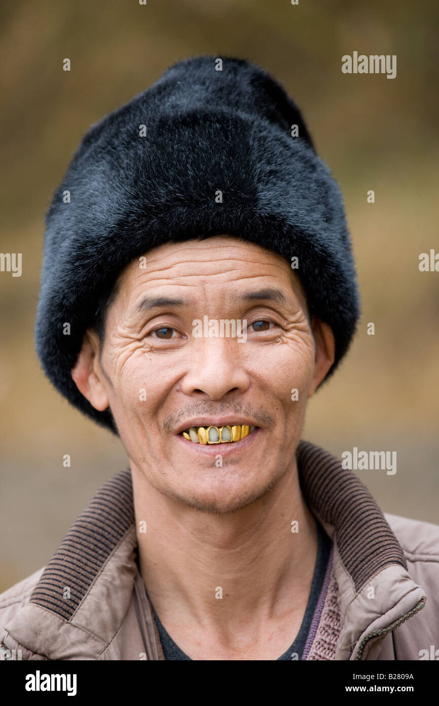 Chinese man wearing fur hat in Guilin China Stock Photo