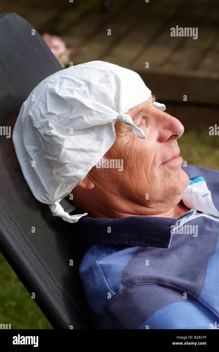 Man wearing a white cotton knotted handkerchief on his head Stock Photo -  Alamy