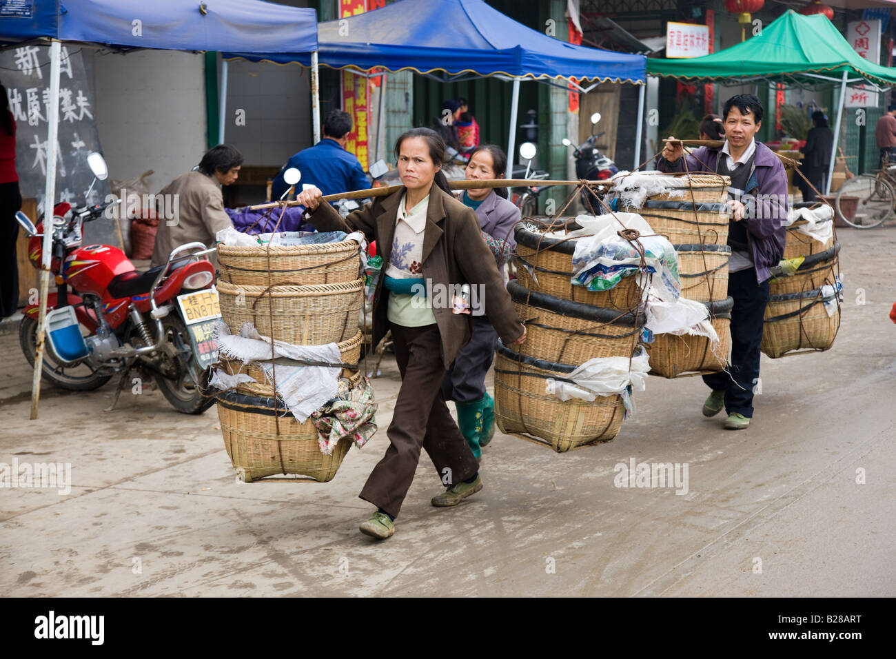People carry baskets to market day in Baisha near Guilin China Stock Photo