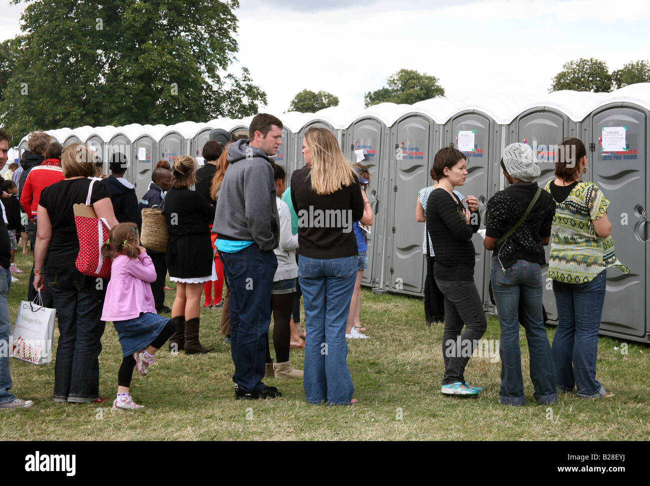People queue for toilets at London festival Stock Photo