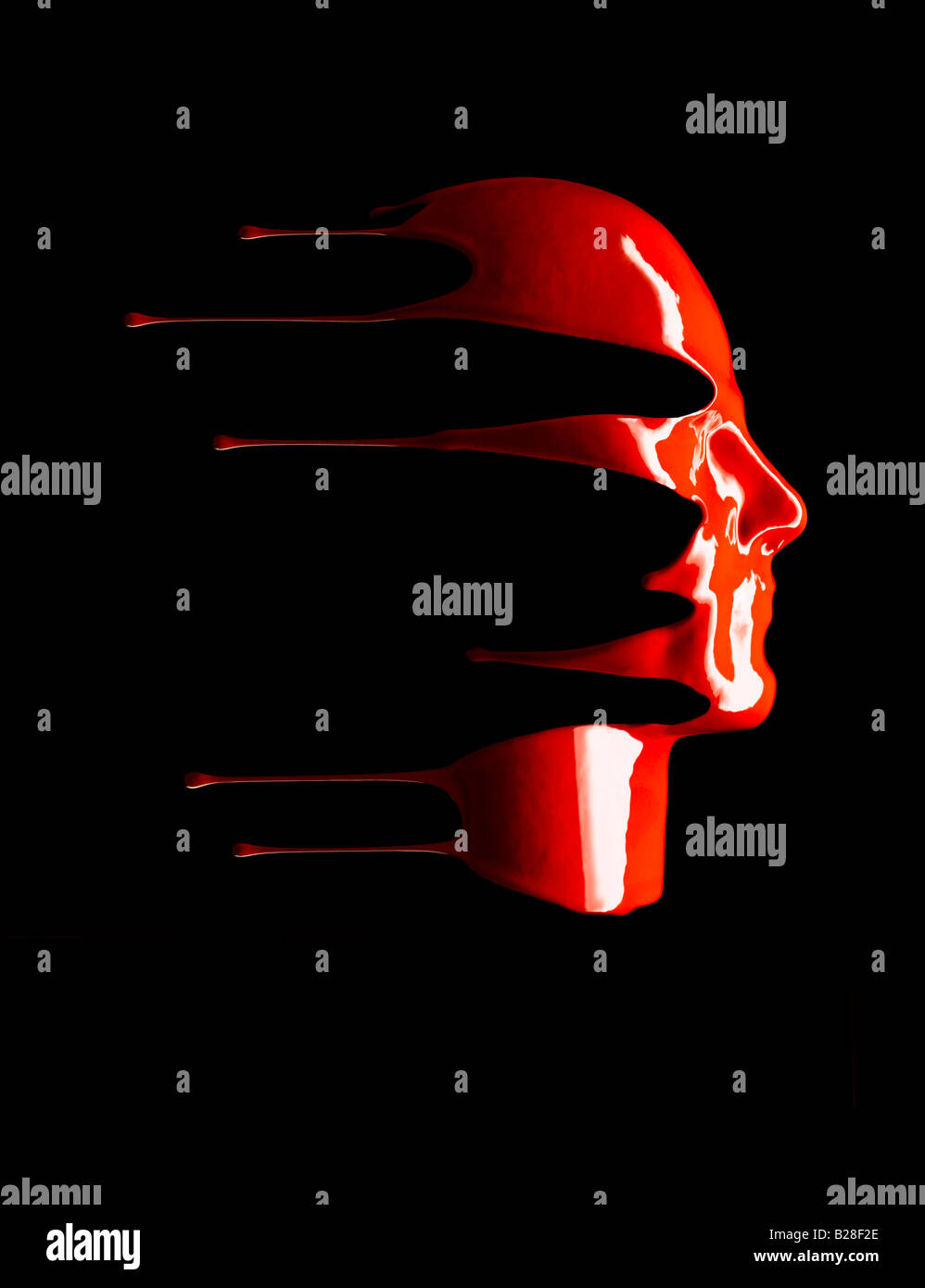 Red liquid dripping down a face. Stock Photo